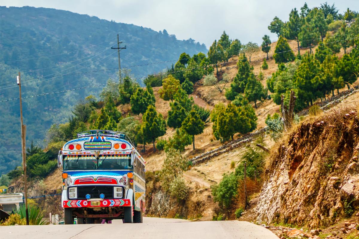Guatemala transportation - colorful chicken buses on a mountain road